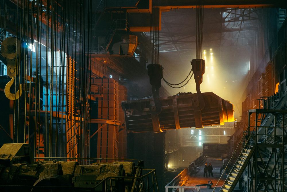 Crane lifting a molten metal ladle in a steel mill. Photo: Ant Rozetsky / Unsplash
