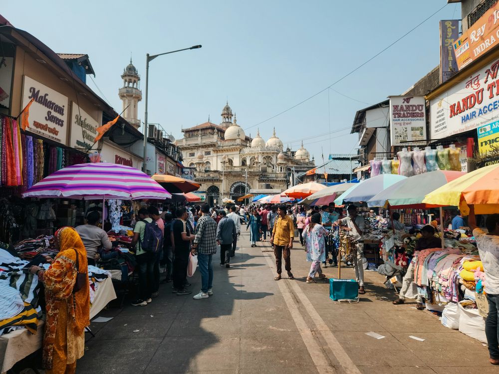 Shoppers walking past market stalls in India. Photo: Zoshua Colah / Unsplash