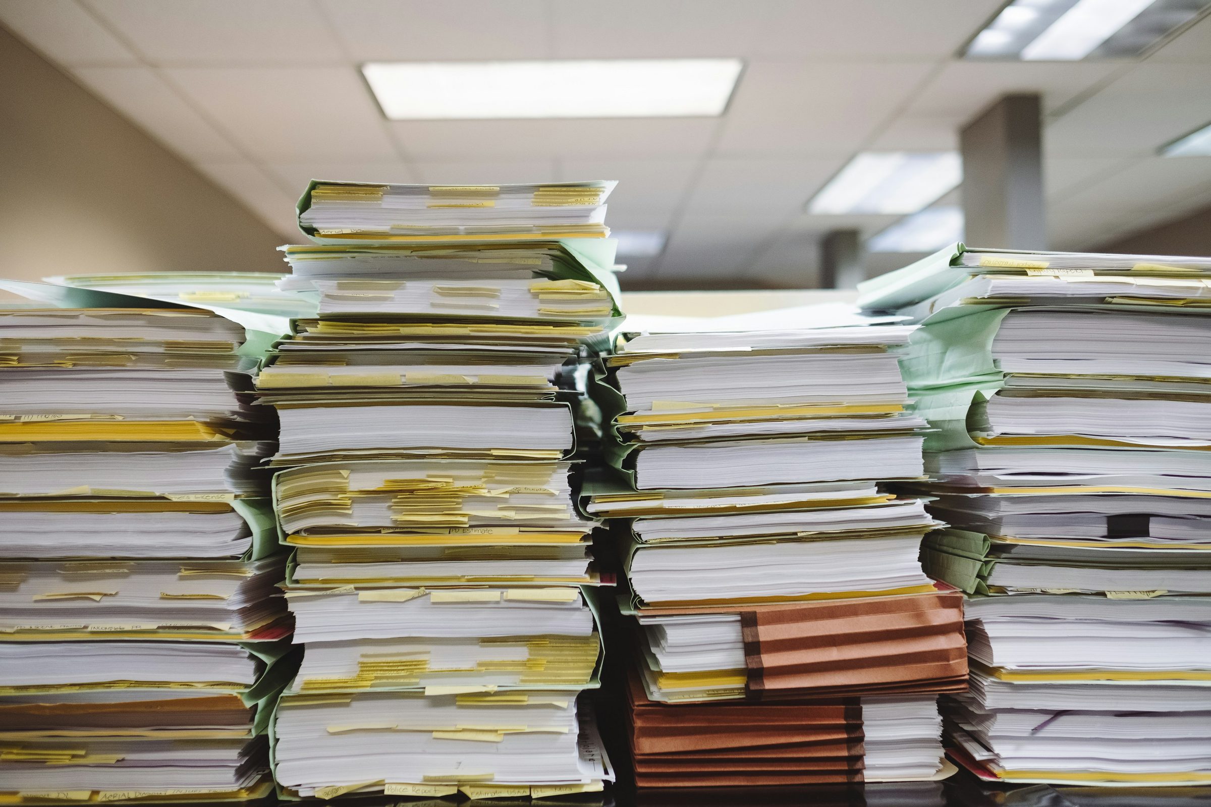 Stacks of case files and folders. Photo: Wesley Tingey / Unsplash